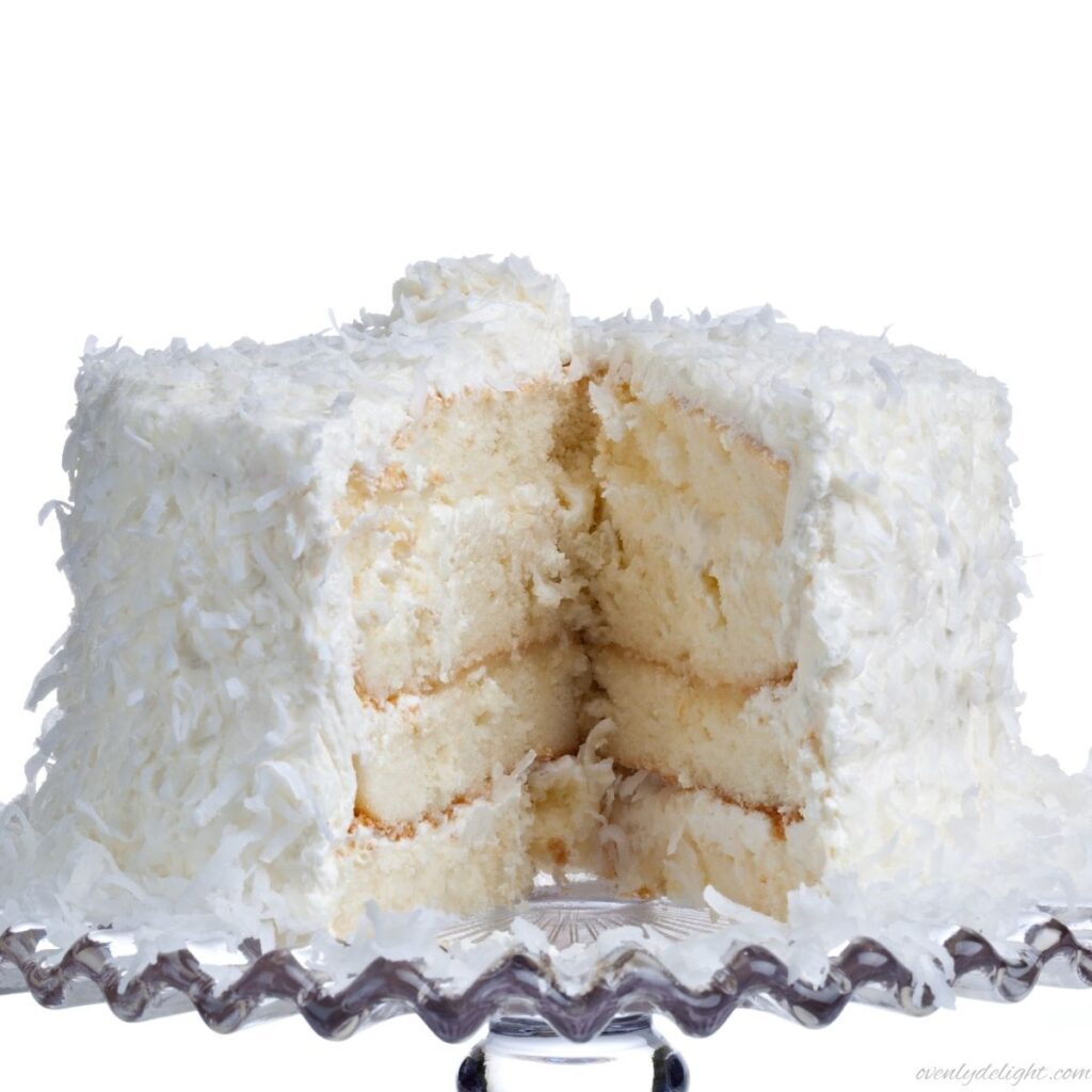 Soft and moist coconut layer cake topped with shredded toasted coconut