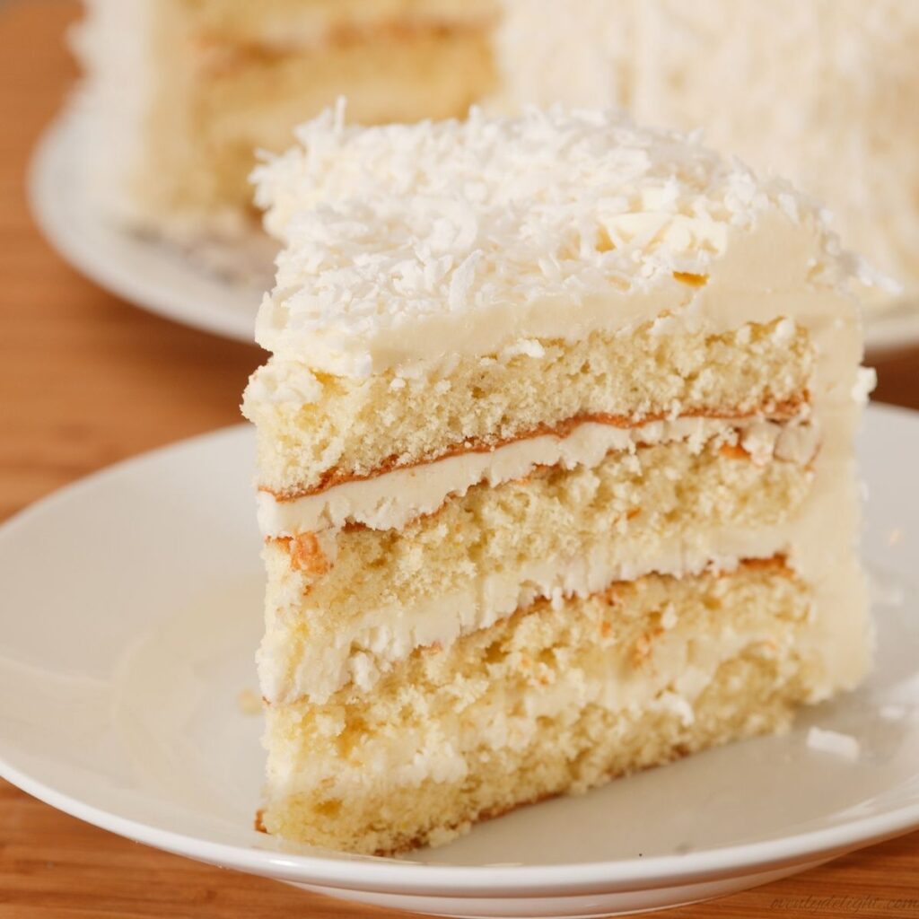 Three-layer coconut cake made from scratch with rich coconut milk and fluffy frosting