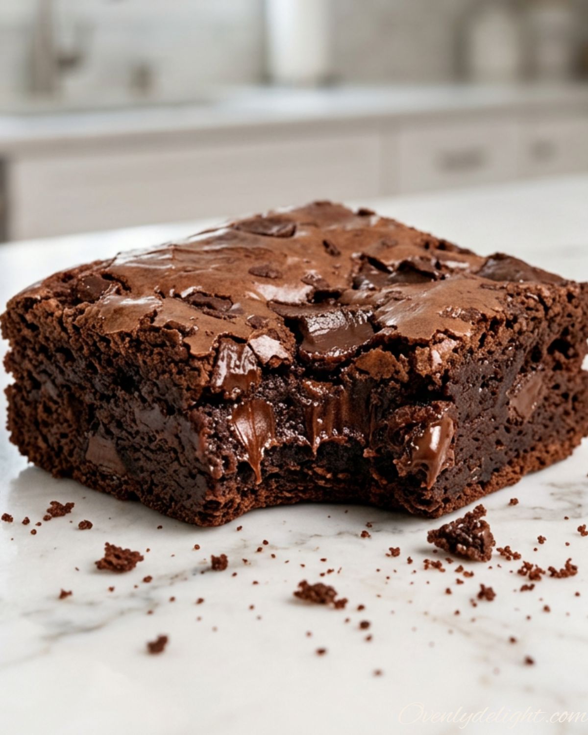 Homemade fudgy brownies cut into neat squares on parchment paper
