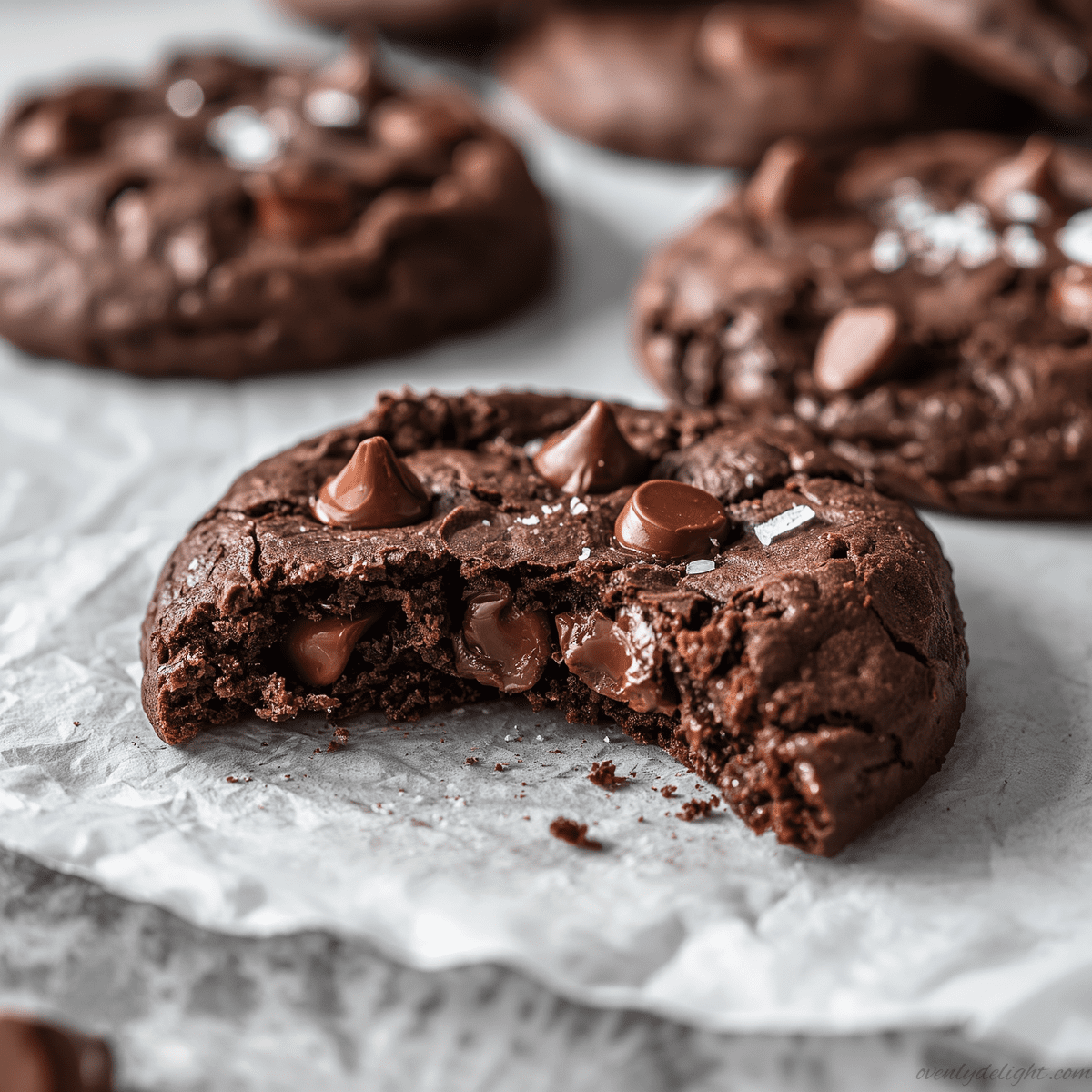 Close-up of fudgy double chocolate chip cookies with melted chocolate chunks and a soft, gooey center on a baking tray