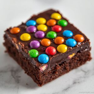 Close-up of rich chocolate Cosmic Brownies with glossy ganache and rainbow candy sprinkles on top