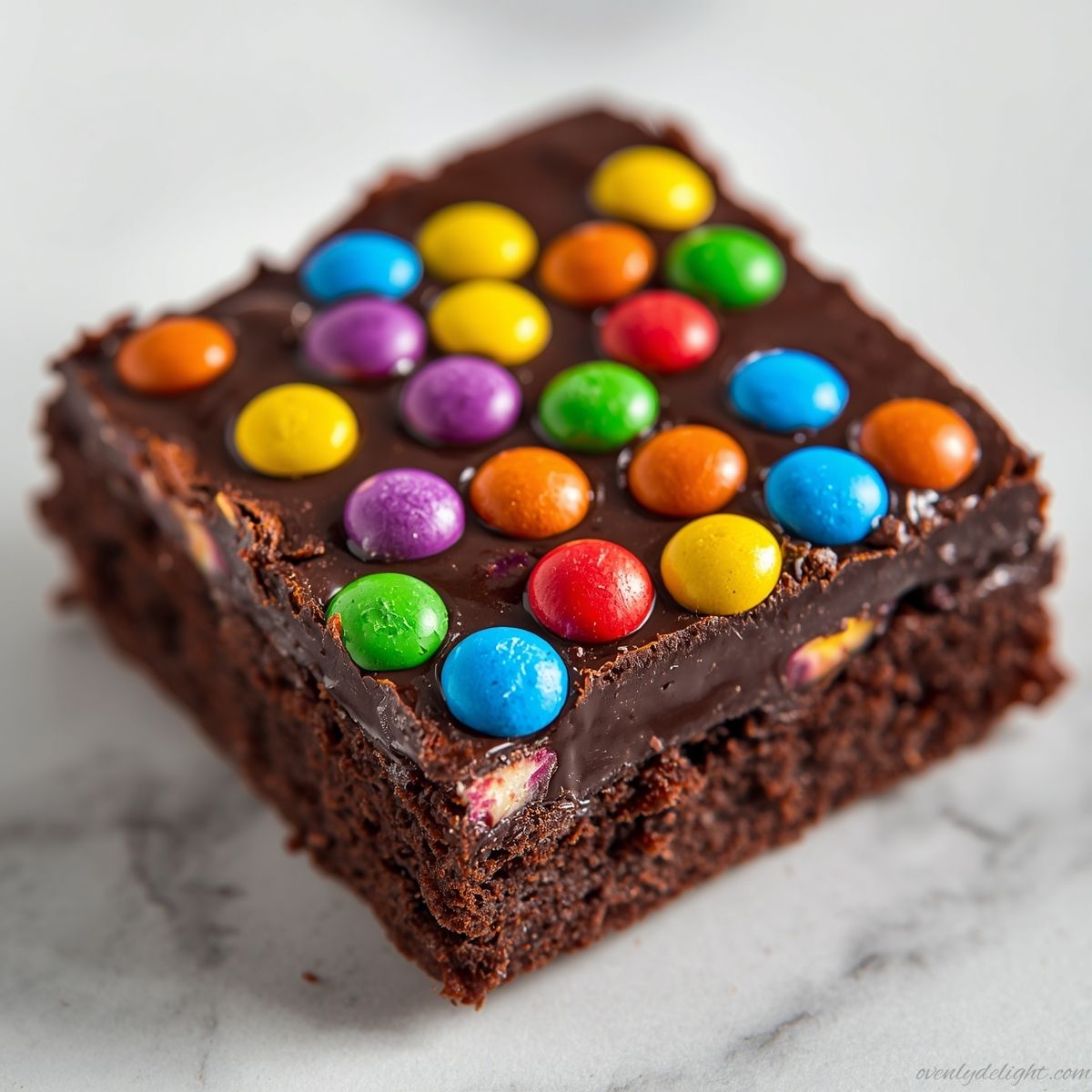 Close-up of rich chocolate Cosmic Brownies with glossy ganache and rainbow candy sprinkles on top