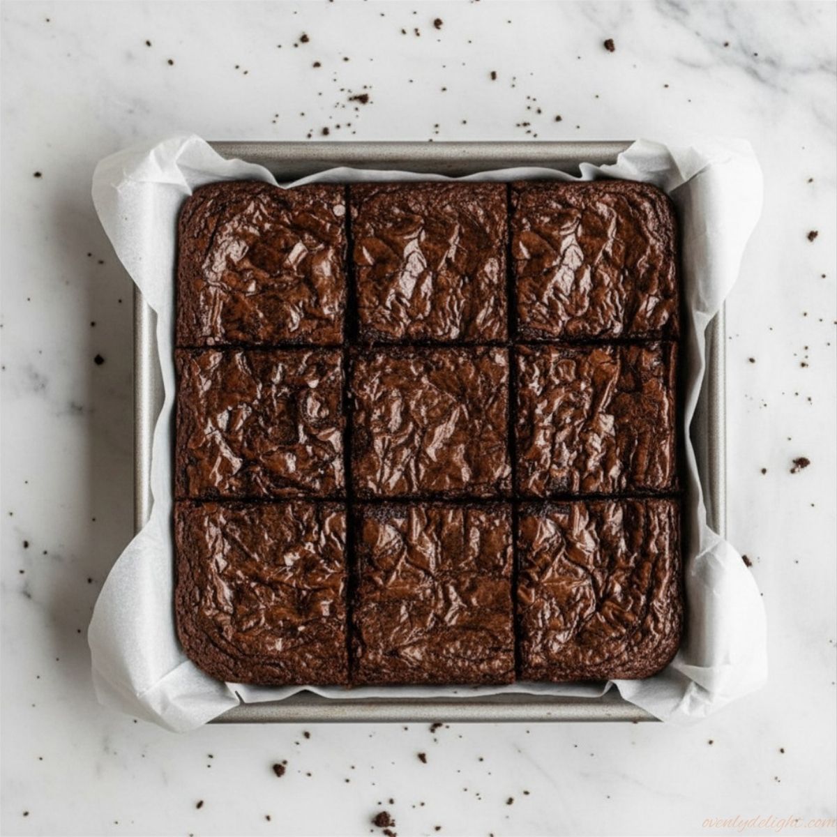 Fudgy brown butter brownies with crackly top in baking pan