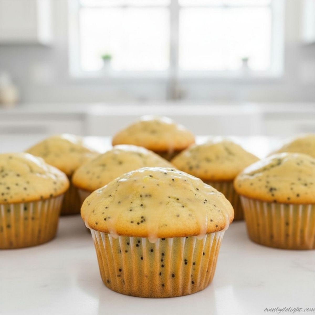 Soft and moist lemon poppy seed muffins topped with sweet lemon glaze and poppy seeds
