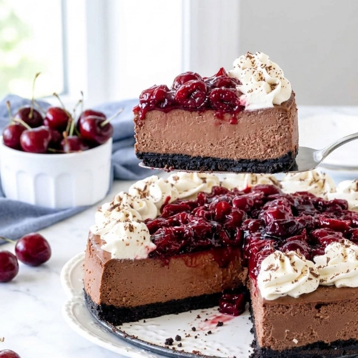 Black Forest cheesecake topped with cherries and whipped cream