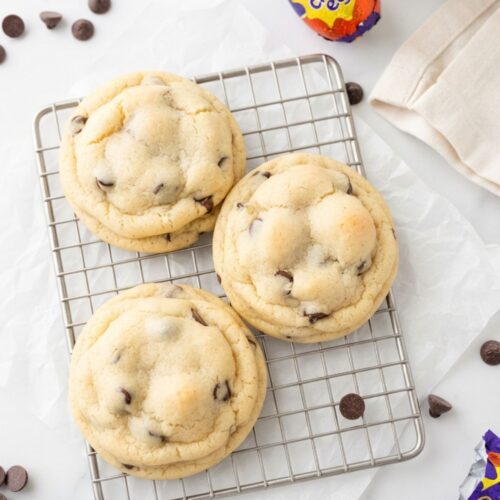 Cream Egg Stuffed Cookies baked with a gooey Cadbury Cream Egg center and chocolate chip cookie dough.