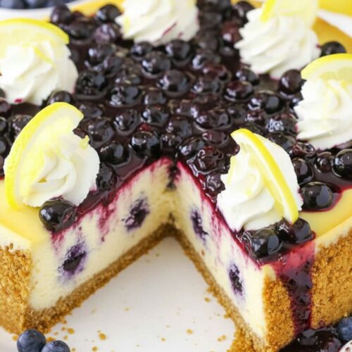 Easy Lemon Blueberry Cheesecake on a graham cracker crust with fresh blueberry sauce.