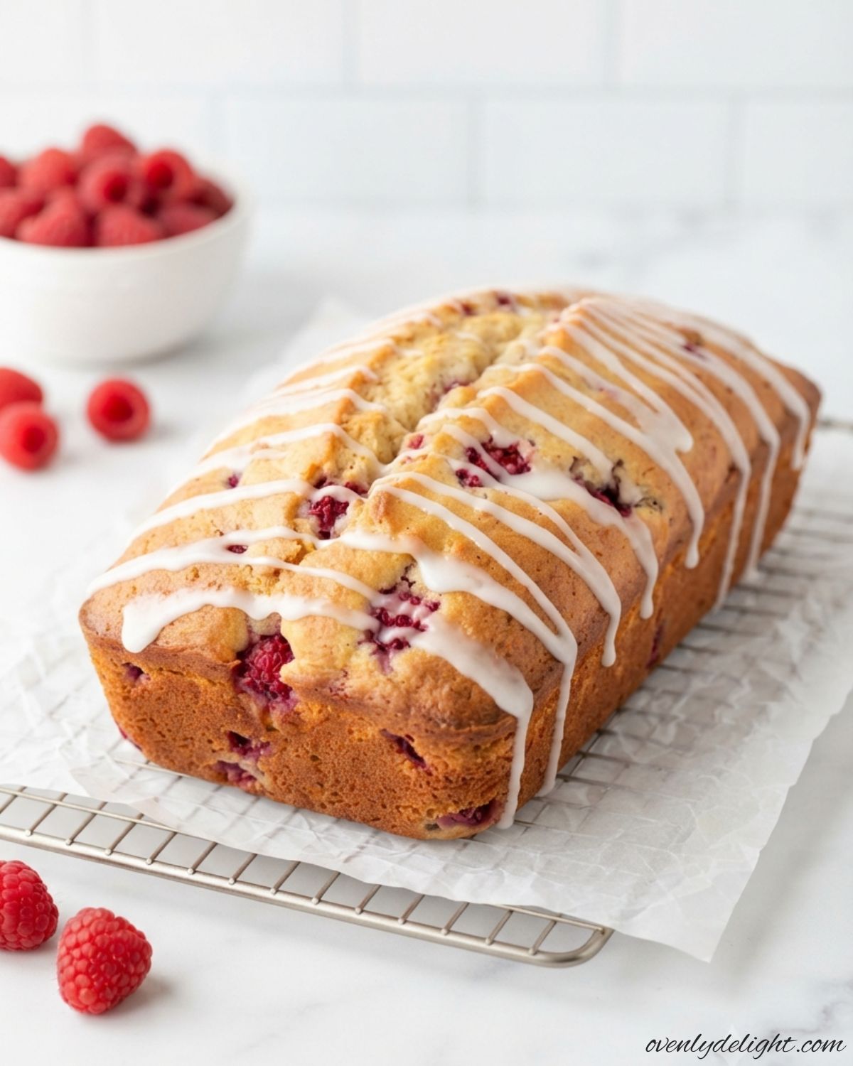 Freshly baked raspberry bread sliced to show juicy raspberries in every bite