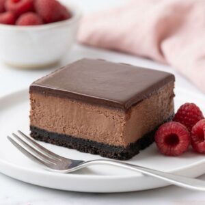Slice of chocolate cheesecake bar with Oreo cookie crust