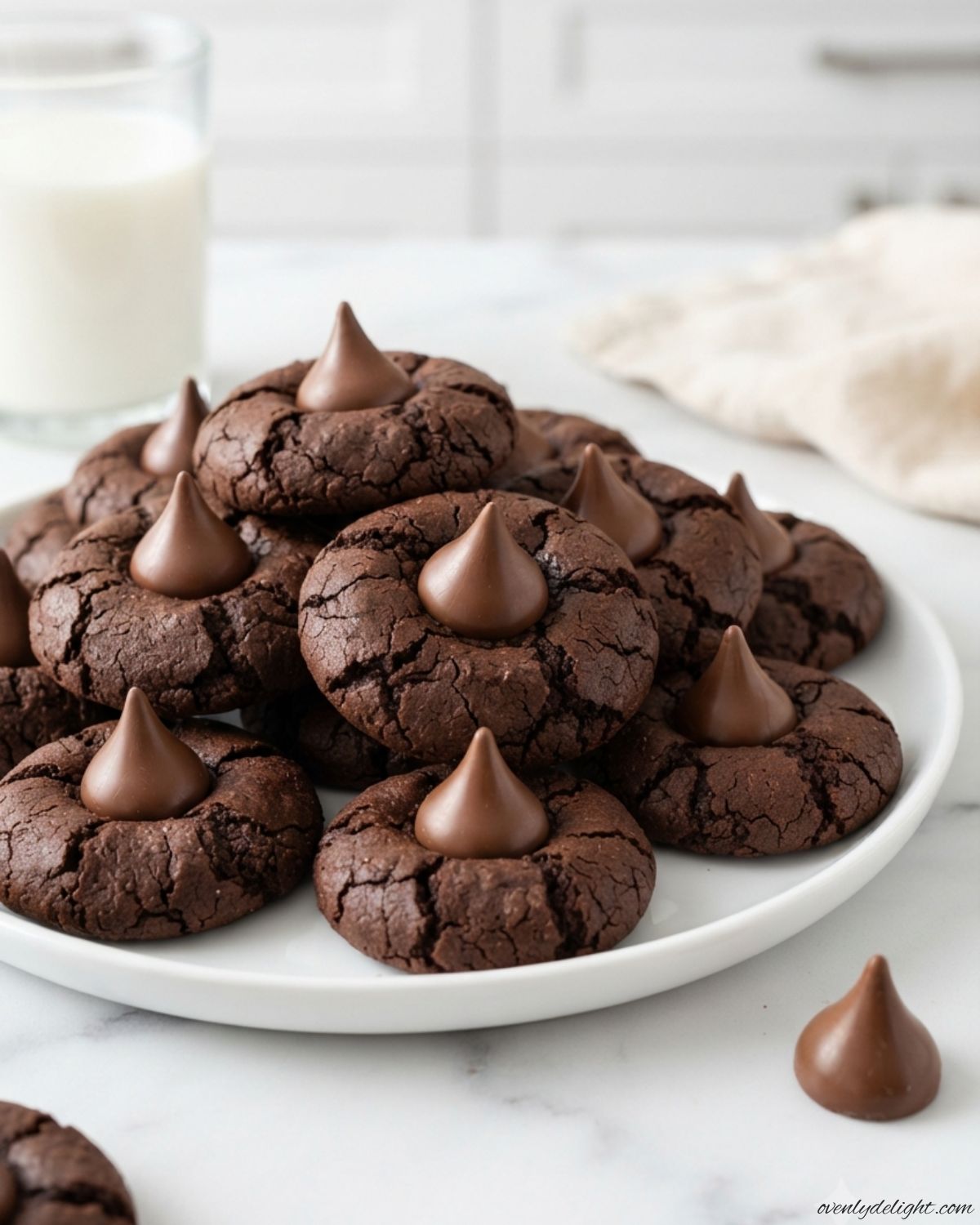 Soft Chocolate Blossom Cookies rolled in sugar and finished with a chocolate kiss for a classic holiday treat.