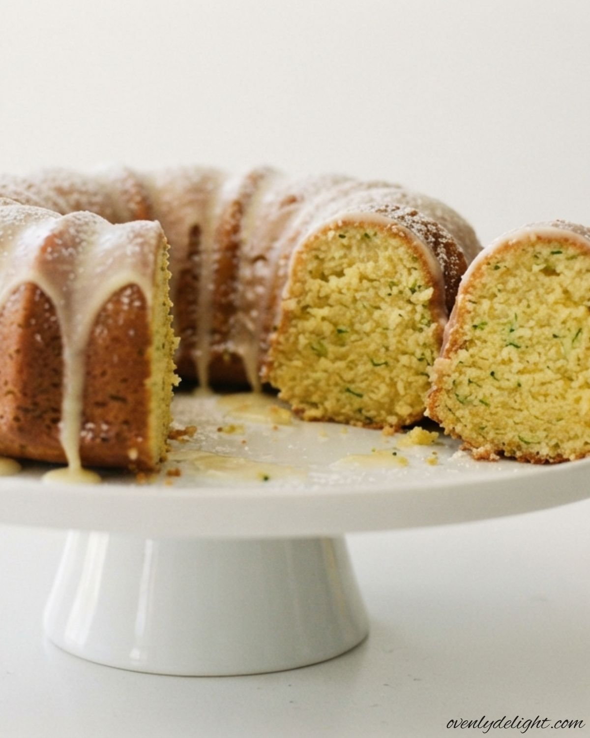Fresh lemon zucchini loaf cake topped with a light lemon glaze, bakery-style presentation.